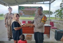 Bhabinkamtibmas Polsek Bambalamotu Dampingi Penyaluran Bantuan Pangan Untuk Warga Desa Binaan