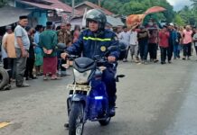 Bhabinkamtibmas Bambalamotu Laksanakan Pengamanan dan Pengawalan Jenazah di Desa Randomayang