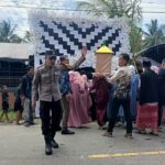 Bhabinkamtibmas Polsek Bambalamotu Amankan Pesta Pernikahan, Pastikan Situasi Kondusif dan Lalu Lintas Lancar