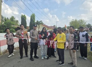 Bhabinkamtibmas Polsek Bambalamotu Amankan Jalan Sehat dan Senam dalam Rangka HUT Pramuka Ke-65 di Kecamatan Sarjo